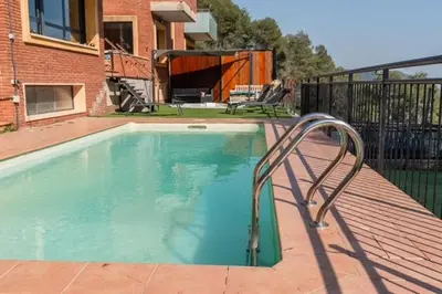 an exterior view of a house with a swimming pool at Can Camarassa Escapada Relax con Piscina y Jacuzzi in Cervelló