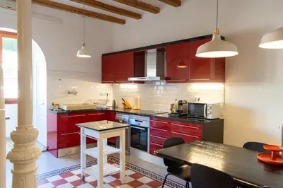 a kitchen with red cabinets and a table at 