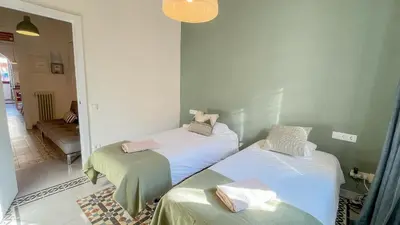 two beds in a room with a hallway at 