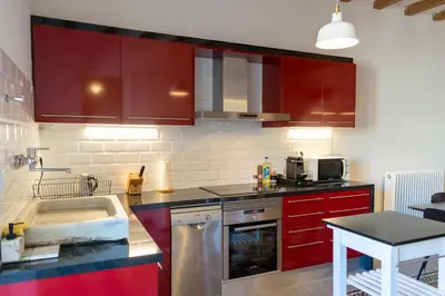 a kitchen with red cabinets and a sink at 