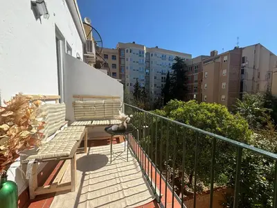 a balcony with a bench and some buildings at Piso en gracia de 3 habitaciones dobles suits in Barcelona