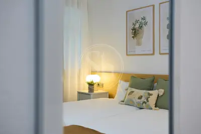 a white refrigerator in a room with a picture at Céntrico apartamento in Barcelona