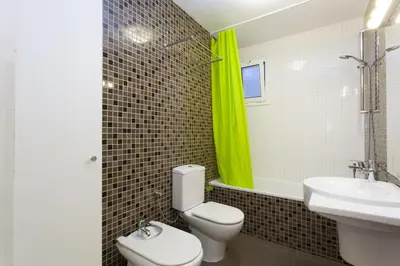 a bathroom with a white toilet and a sink at Céntrico apartamento in Barcelona