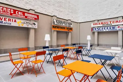 a group of tables and chairs in a room at easyHotel Barcelona La Sagrera in Barcelona