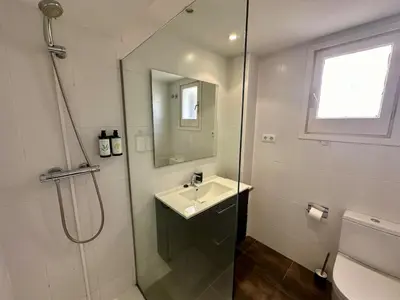a white bathroom with a sink and a shower at Spacious 1 bedroom home in Bonanova in Barcelona