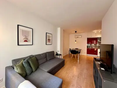 a living room with a couch and a television at Spacious 1 bedroom home in Bonanova in Barcelona