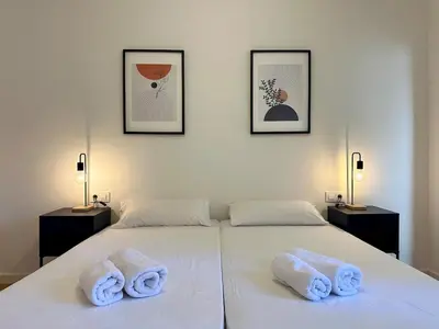 a bedroom with two towels on a white bed at Spacious 1 bedroom home in Bonanova in Barcelona
