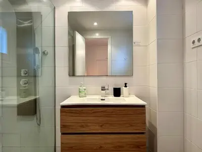a bathroom with a sink and a mirror at Spacious 1 br home in Bonanova in Barcelona