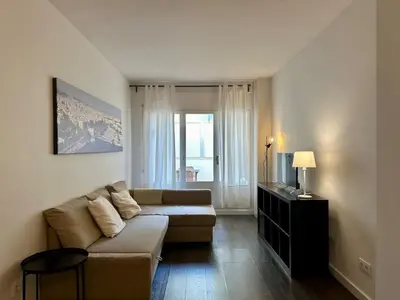a living room with a couch and a window at Spacious 1 br home in Bonanova in Barcelona