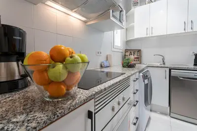 a bowl of fruit on a counter in a kitchen at Habitat Apartments Cool Jazz in Barcelona
