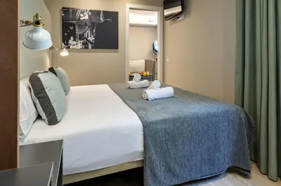 a hotel room with a bed with towels on it at Habitat Apartments Cool Jazz in Barcelona