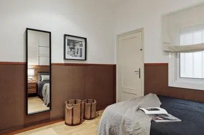 a bedroom with a large mirror and a bed at Sabate - 3 bedrooms and office in Sant Gervasi in Barcelona