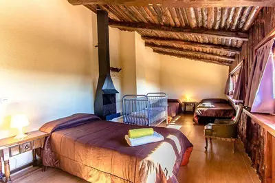 a bedroom with a large bed in a room at Casa Rural CAN PANXA in Sant Pere de Vilamajor