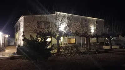a house with a tree in front of it at night at A Country and Vineyard Retreat in San Martín Sarroca