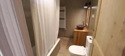 a bathroom with a white toilet and a sink at A Country and Vineyard Retreat in San Martín Sarroca