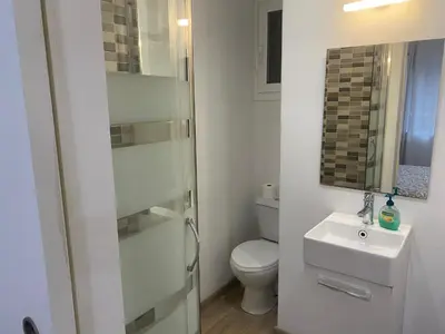 a white bathroom with a toilet and a sink at Apartamento Barcelona in Barcelona