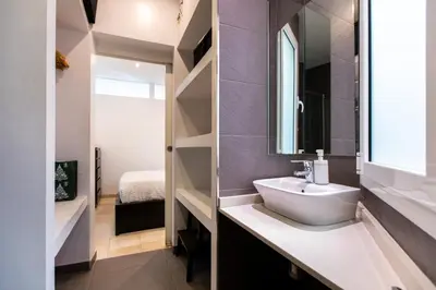 a bathroom with a sink and a mirror at Nice apartment in Gracia - Torrent de l'Olla in Barcelona