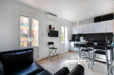 a living room with a couch and a kitchen at Nice apartment in Gracia - Torrent de l'Olla in Barcelona