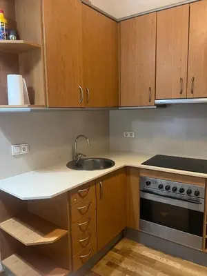 a kitchen with wooden cabinets and a sink and a stove at Flat in centre of Barcelona in Barcelona