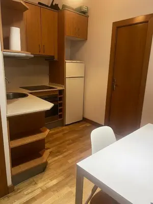 a small kitchen with a white refrigerator and a table at Flat in centre of Barcelona in Barcelona