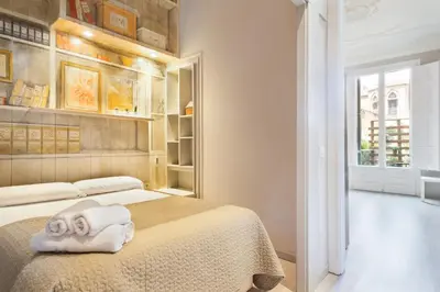 a living room with a couch and a window at Suites4days Ali bei Apartment in Barcelona