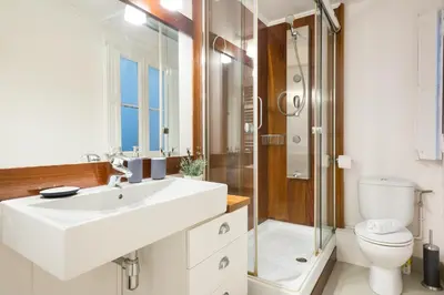 a bathroom with a sink and a shower and a toilet at Suites4days Ali bei Apartment in Barcelona