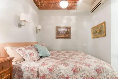 a bedroom with a bed and two pictures on the wall at Explore City Center from an Elegant Urban Retreat in Barcelona