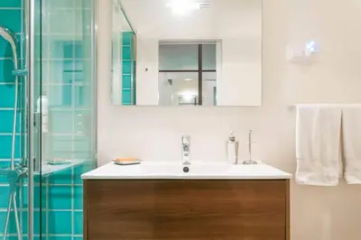 a bathroom with a sink and a shower at Explore City Center from an Elegant Urban Retreat in Barcelona