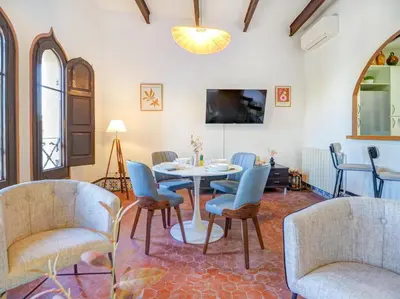 a dining room with a table and chairs at Las Ventanas Sea Front by Hello Homes Sitges in Sitges