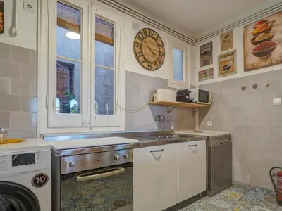 a kitchen with a sink and a stove in it at Las Ventanas Sea Front by Hello Homes Sitges in Sitges