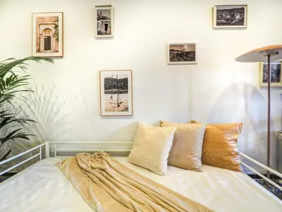 a bed in a room with pictures on the wall at Las Ventanas Sea Front by Hello Homes Sitges in Sitges