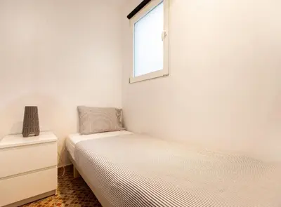 a bedroom with two beds and a window at Tapioles · Lovely apartment in Poble Sec in Barcelona