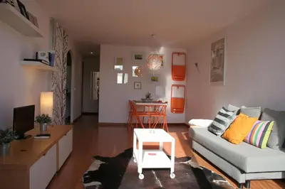 a living room with a couch and a table at Urgell - Lovely apartment with a terrace in Barcelona