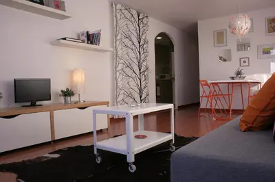 a living room with a table and a tv at Urgell - Lovely apartment with a terrace in Barcelona