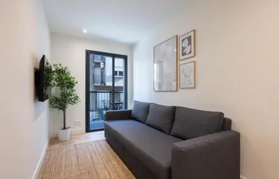 a living room with a couch and a window at Stay U-nique Apartments Font BCN in Hospitalet de Llobregat