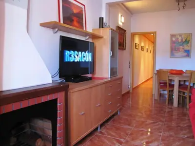 a living room with a tv on top of a fireplace at FlexCo City - Barcelona Flats in Barcelona
