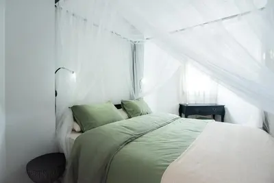 a bedroom with a bed with a white canopy at Casa Jasmine Family Villa near the beach in Barcelona
