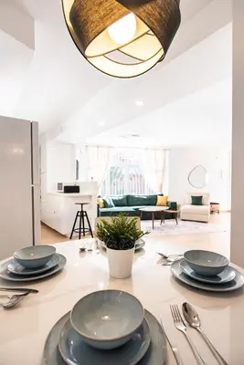 a dining room with a table with plates and silverware at Casa Jasmine Family Villa near the beach in Barcelona