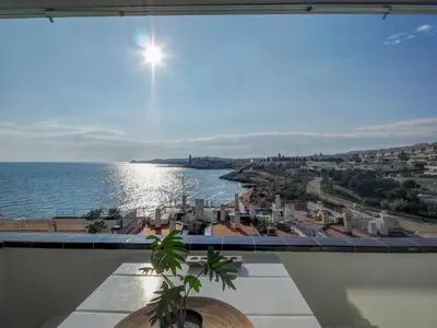 a view of the ocean from a balcony at Sunset apartment by Hello Homes Sitges in Sitges