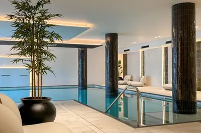 a pool with a palm tree in a house at Golden Taurus Aquapark Resort in Pineda de Mar
