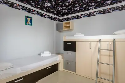 a room with a kitchen with a ceiling with floral wallpaper at Exe Cunit Suites & Spa in Cunit