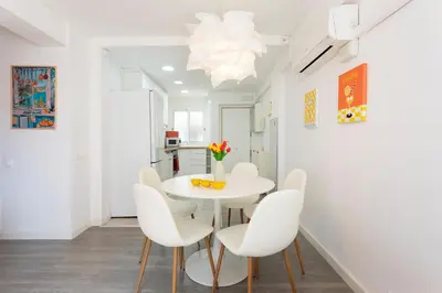 a white dining room with a white table and chairs at Key Barcelona Diagonal Mar in Barcelona