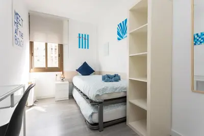 a bedroom with a bed and a book shelf at Key Barcelona Diagonal Mar in Barcelona