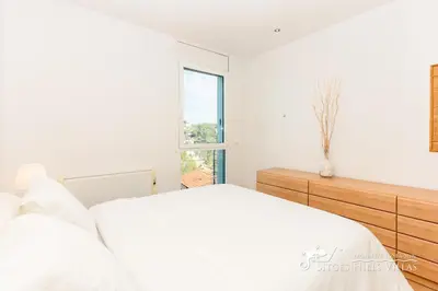 a white bedroom with a large white bed with white pillows at Villa Senita with Private Pool, close to Sitges in Olivella