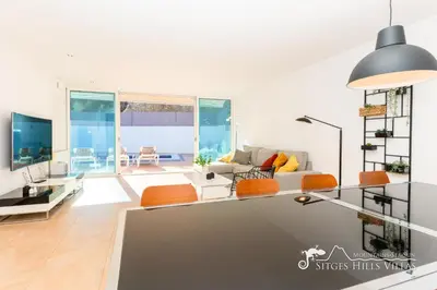 a living room with a couch and a tv at Villa Senita with Private Pool, close to Sitges in Olivella