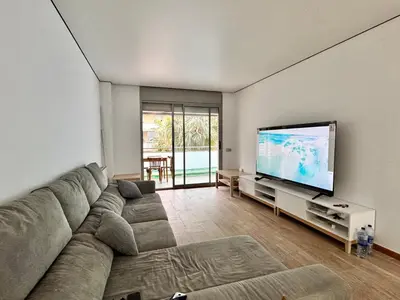 a living room with a couch and a flat screen tv at Apt compartido martirrena in Badalona