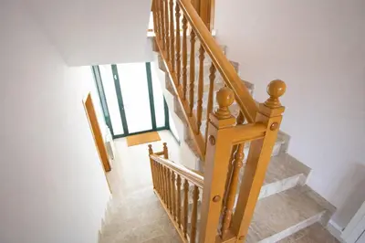 a staircase with wooden railings in a house at Nature & Tranquility only 25km from Barcelona in Torrelles de Llobregat