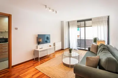 a living room with a couch and a table at Mai&Maud Fira Apartment in Hospitalet de Llobregat