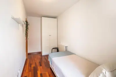 a small bedroom with a bed and a closet at Mai&Maud Fira Apartment in Hospitalet de Llobregat