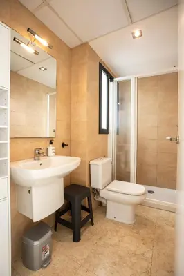 a bathroom with a toilet and a sink and a shower at Sunset Penthouse in Sitges